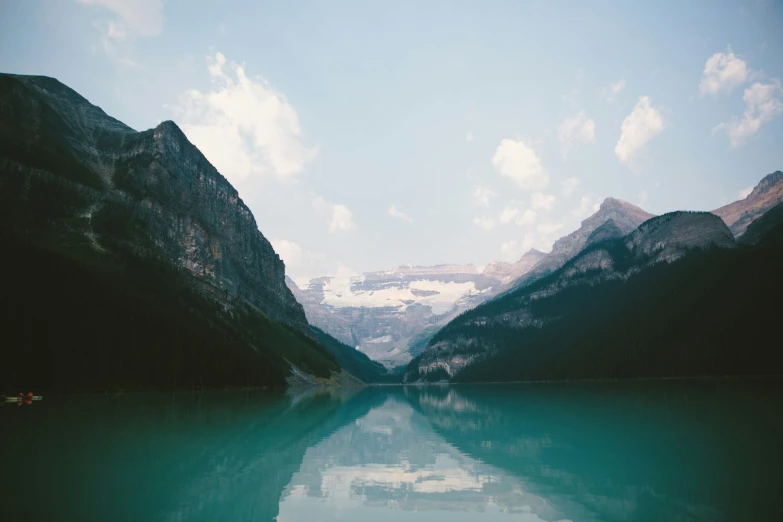 two mountains sit above the calm water