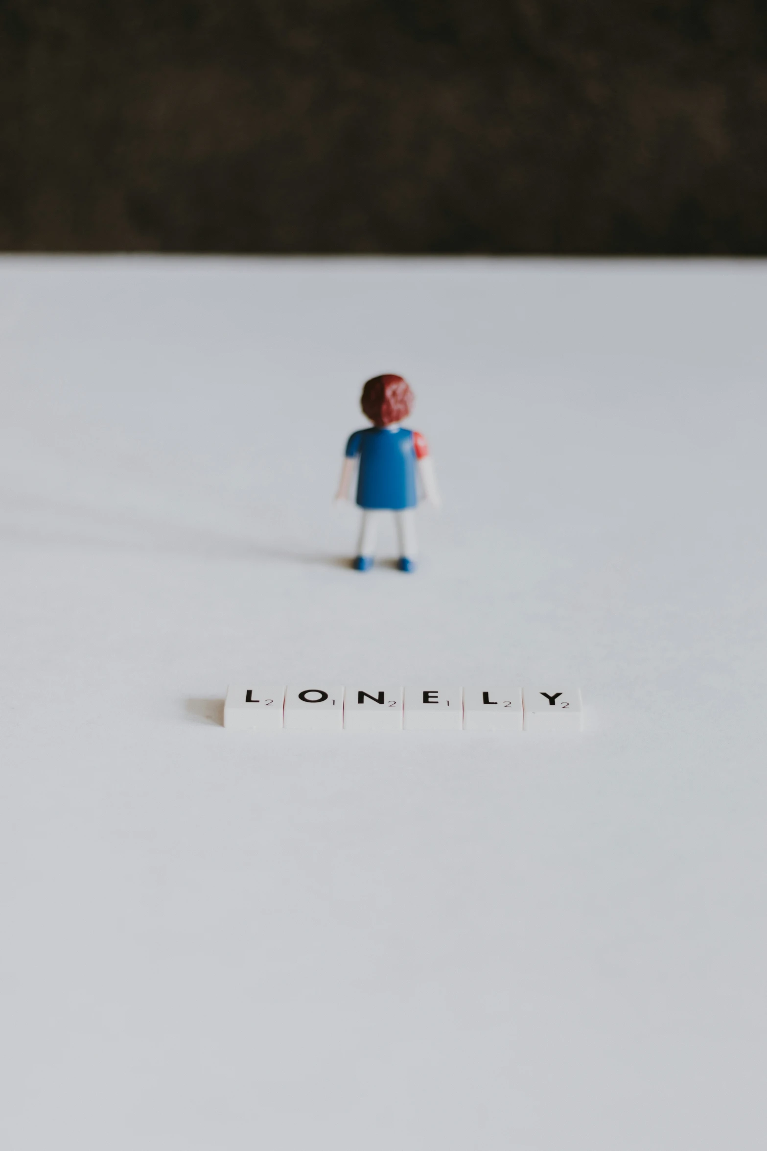 tiny person on a piece of paper with the word lonely