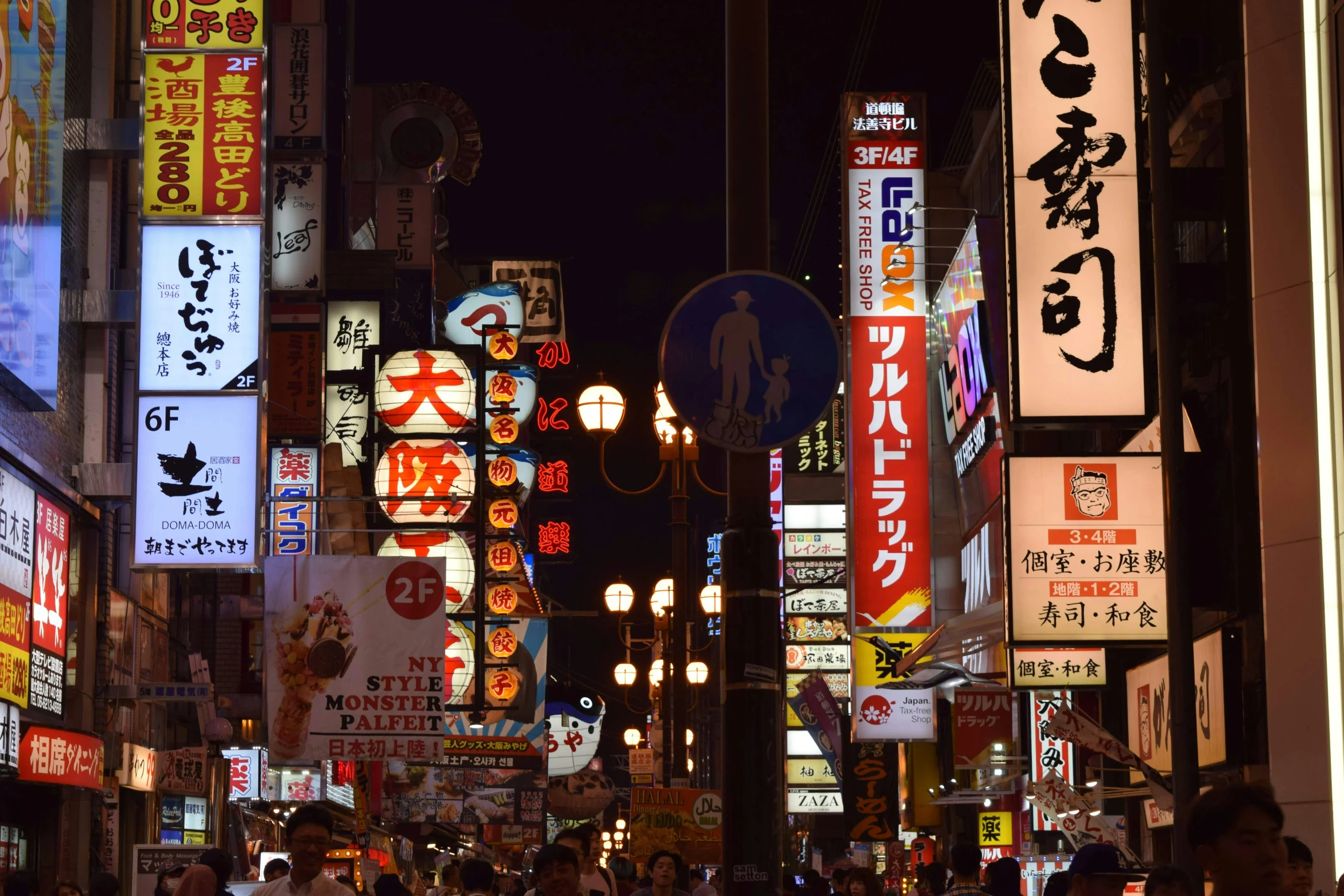 a busy urban street filled with lots of signs