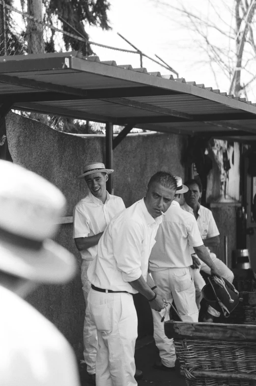 men standing in line at a vendor with baskets