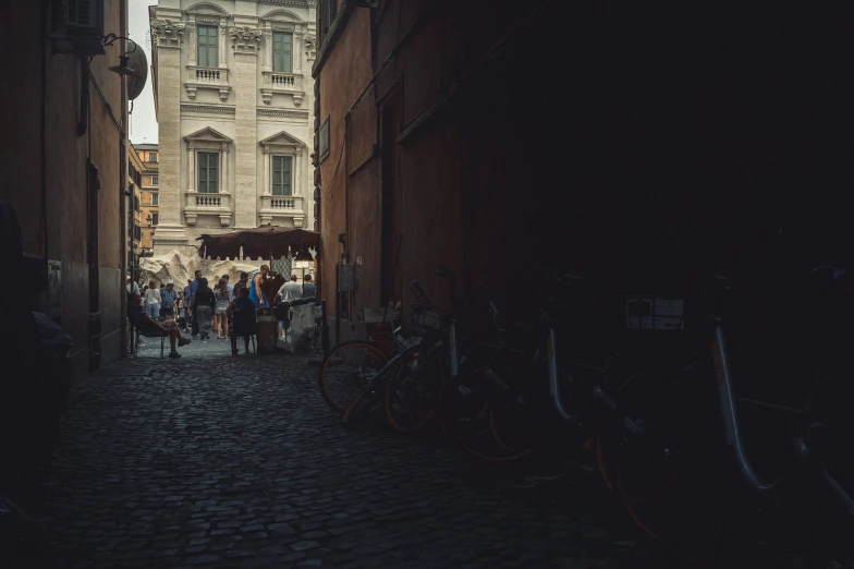 many people walking on the street at dusk