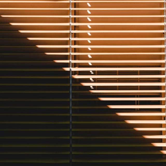 a wall with the shadows of two large shutters on it