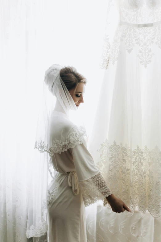 there is a bride that is leaning down against a curtain