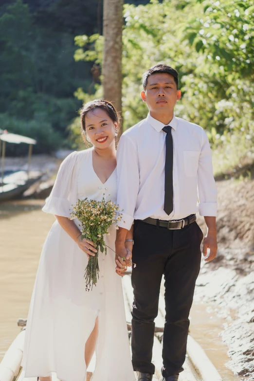 a man and woman walking in the dirt