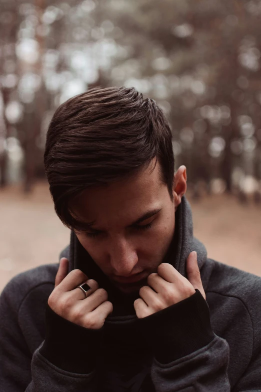 a man with his fingers on his face and holding his hand near his ear