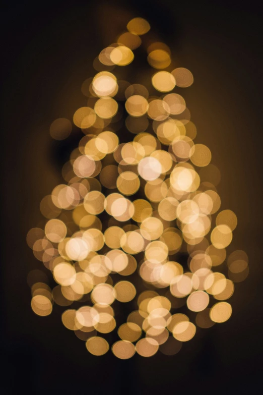 a large lit up christmas tree with a dark background