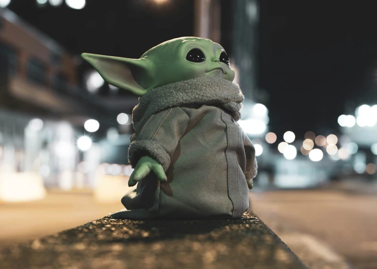 a small toy is sitting on the edge of a ledge