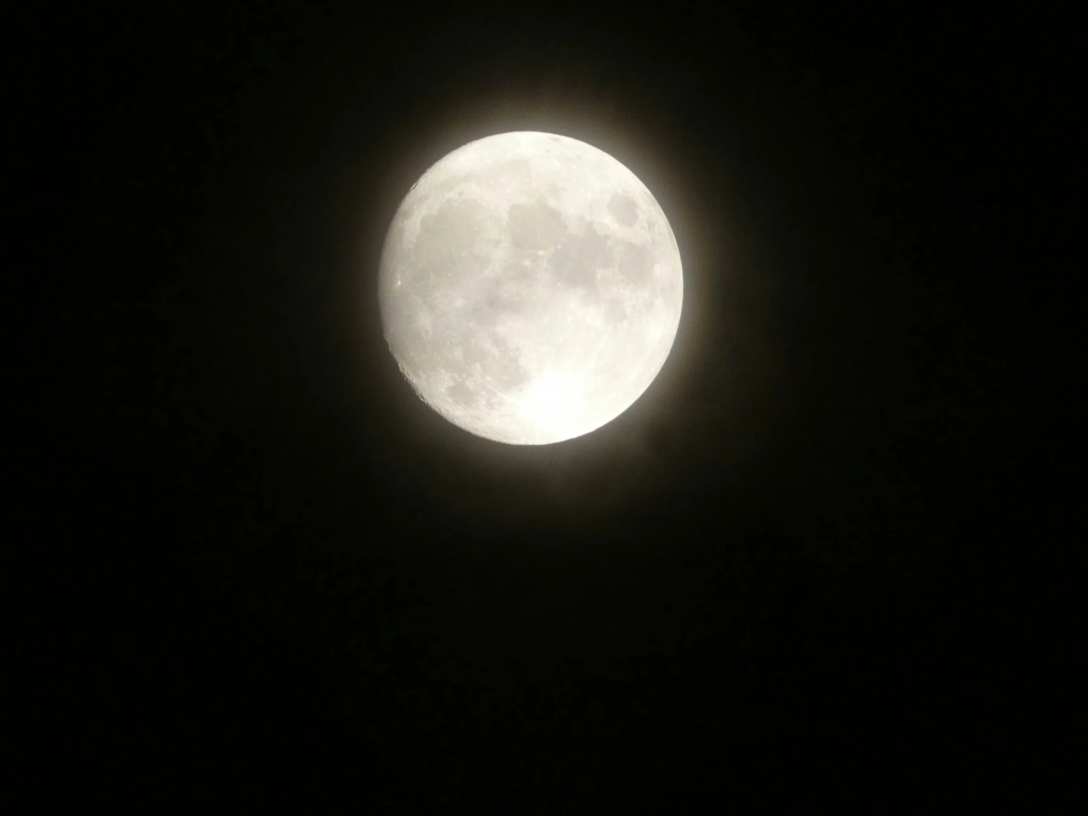 an eclipse or full moon shining in a dark night sky