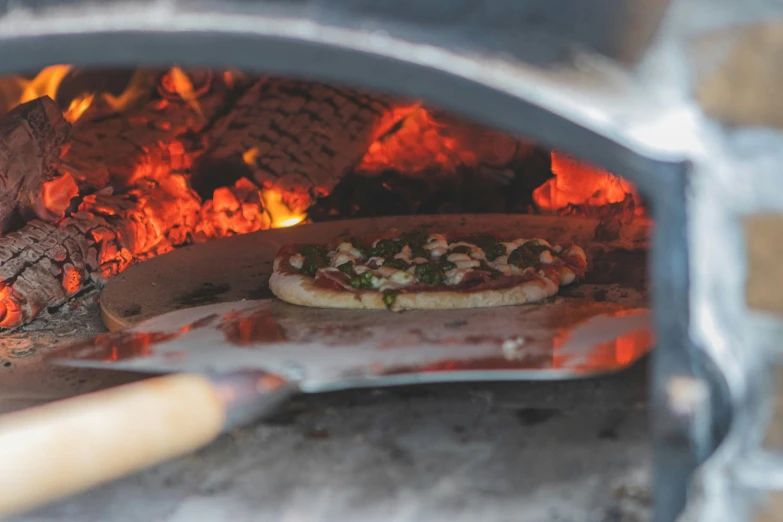 a pizza sitting inside of an open oven