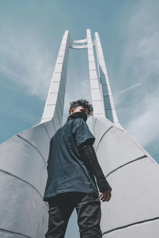 a man standing near a structure with his feet on the ground