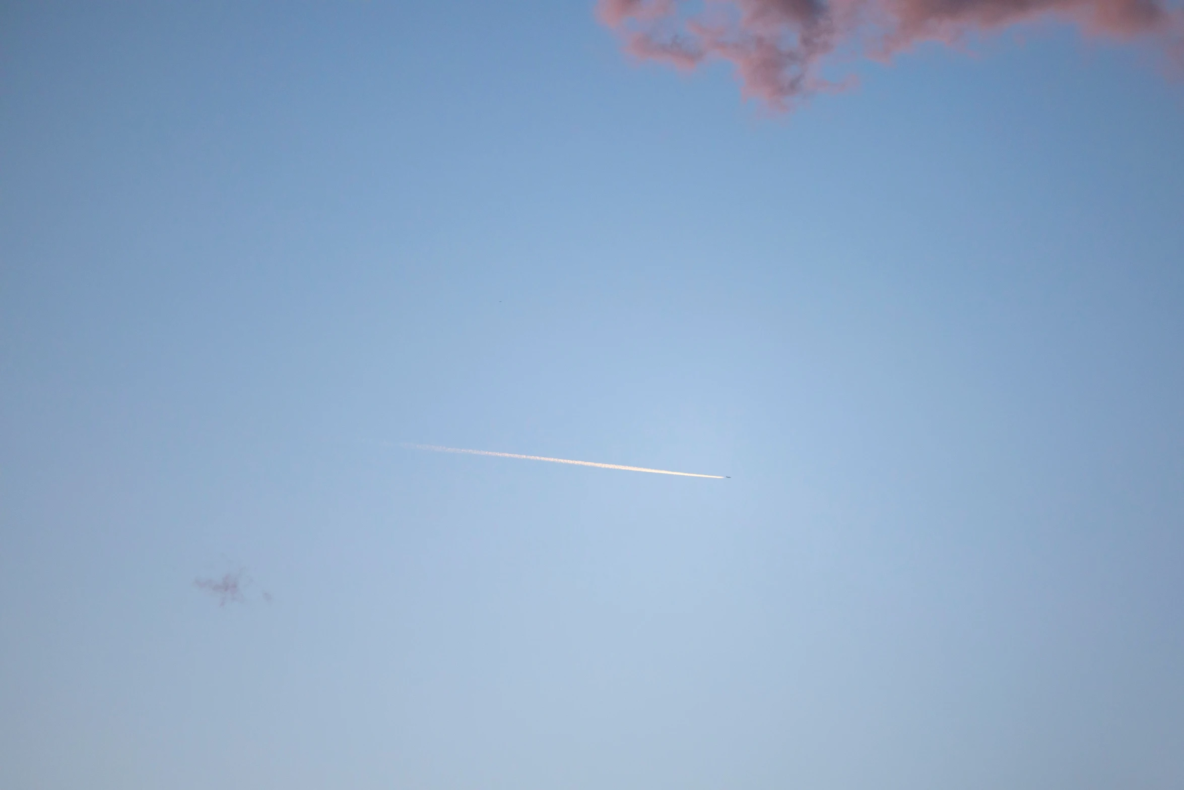 a jet is flying against a clear sky