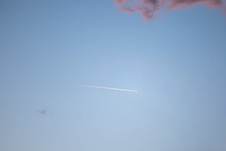 a jet is flying against a clear sky