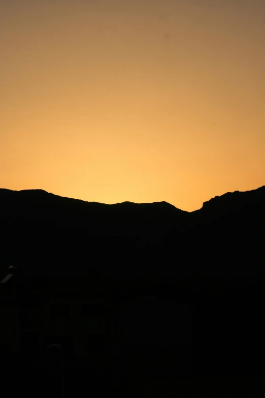 an airplane flying low in the sky near some mountains