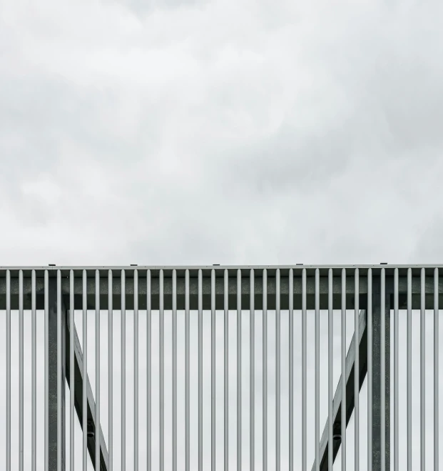 a white bird is standing on the railing near a bench