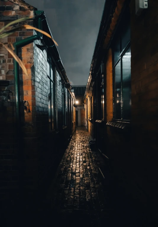 an alley way is lit up with lanterns