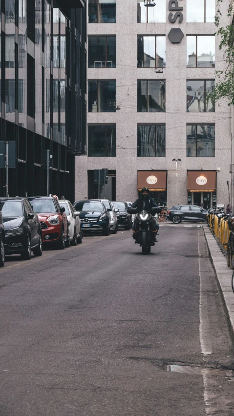 a person on a motor bike riding down a street