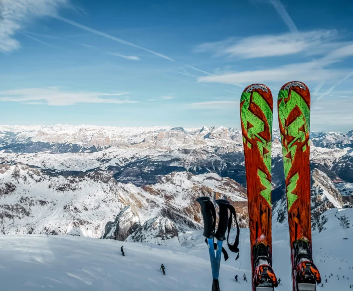 someone is standing on a mountain looking back at his skis