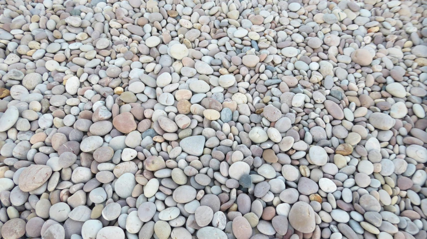 a lot of small rocks sitting on top of a gravel road