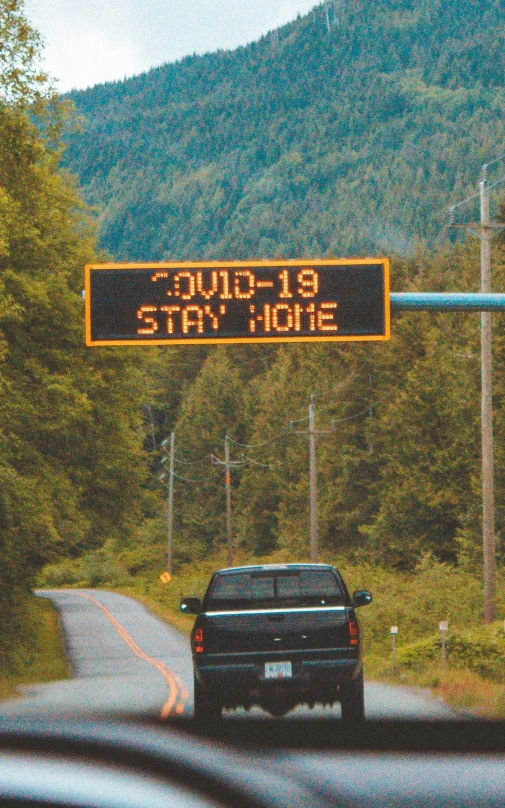 a truck drives down the road towards a stop sign that says 8 19