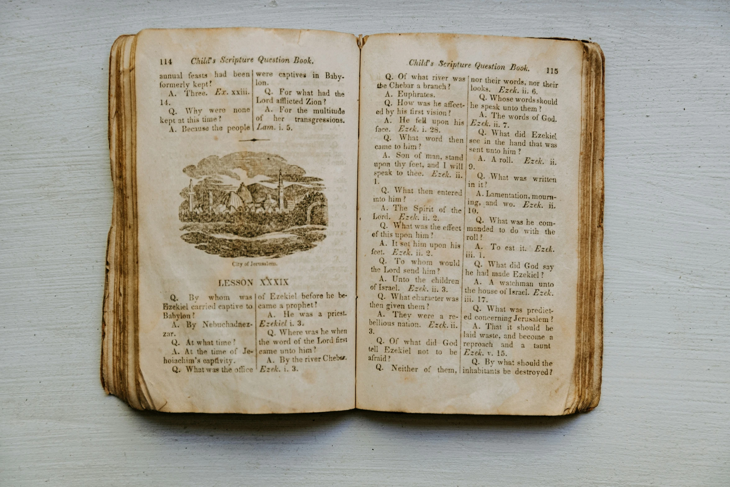 an old book with some pages opened showing words