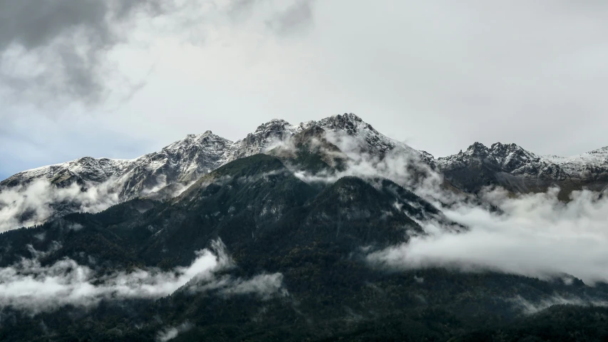 a view of some mountain range covered in clouds