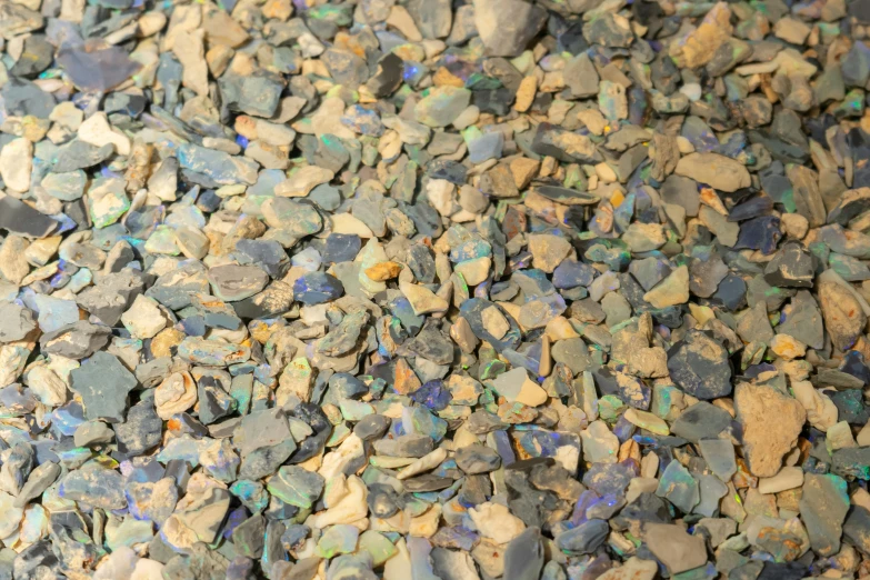 a pile of small rocks are in blue and green