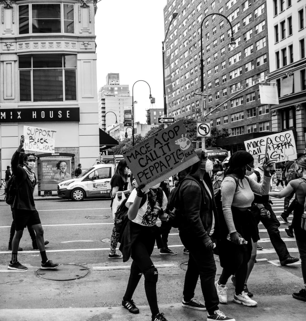 a group of people walking across a street