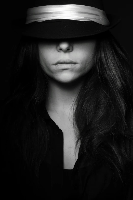 black and white image of woman with hat on head