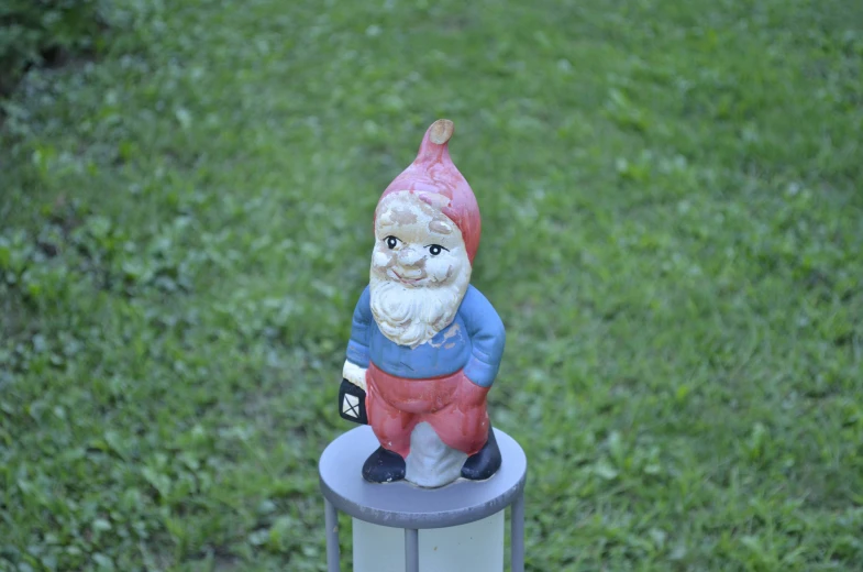 there is a gnome figurine that has been placed on top of a post