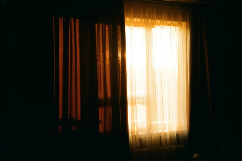 a window with curtains in the dark