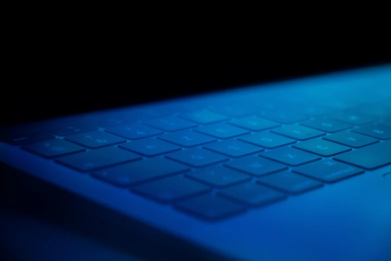 a laptop computer keyboard glowing in the dark