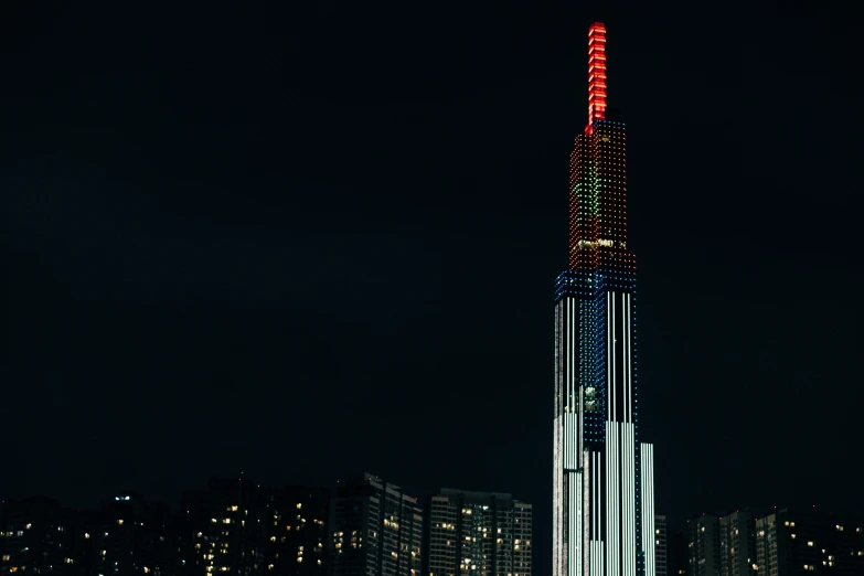 the lights and colors of a building glow brightly at night