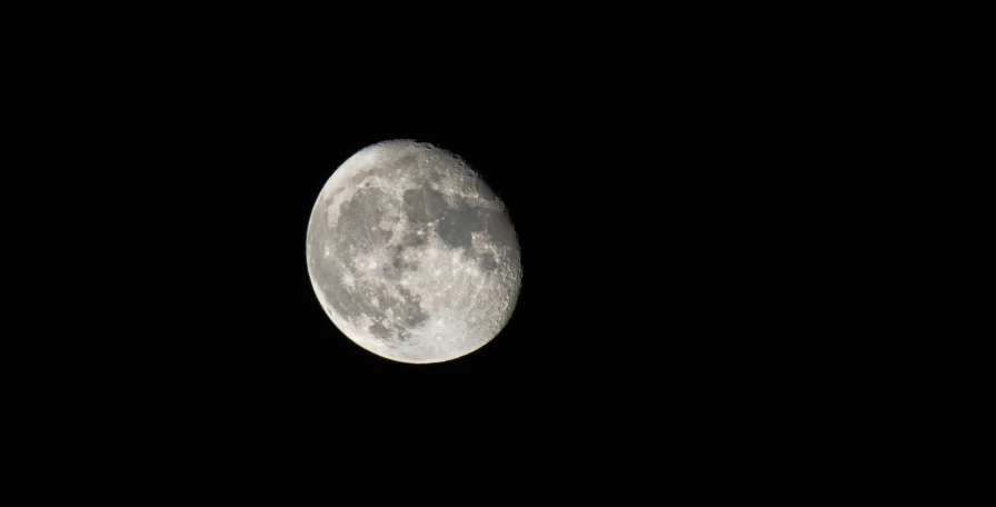 a half moon in the middle of a dark sky