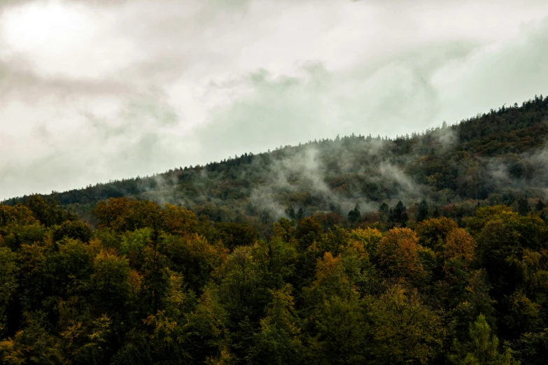 some very thick clouds in front of some mountains