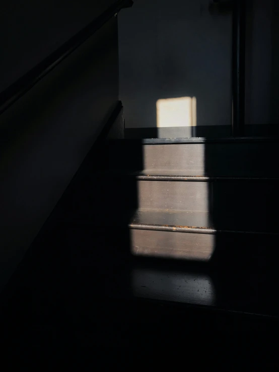 shadows cast on the floor by some stairs