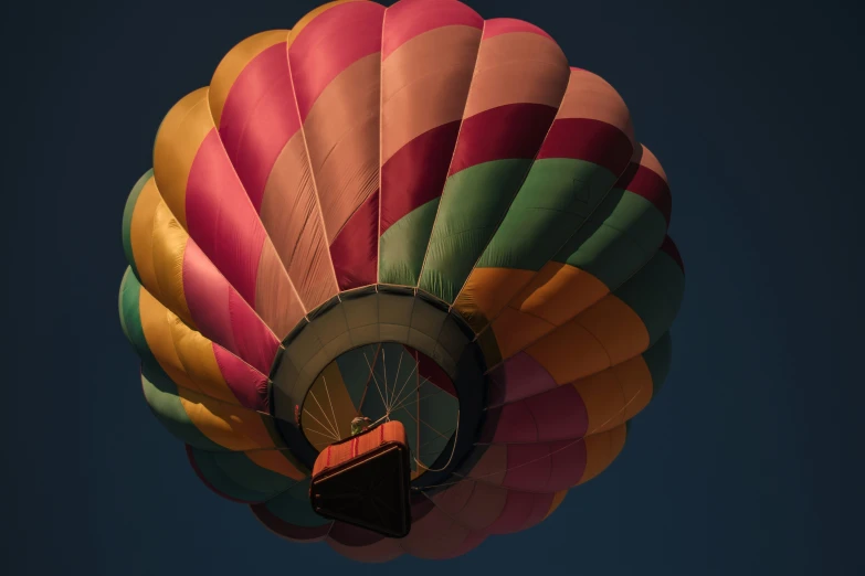 there is a large multi - colored balloon that has a sky background