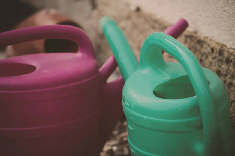 two plastic jugs sitting on the ground