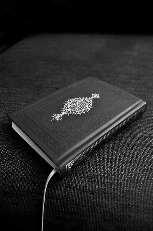 a black and white po of a book with a golden key