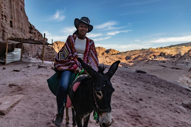 a man riding on the back of a donkey