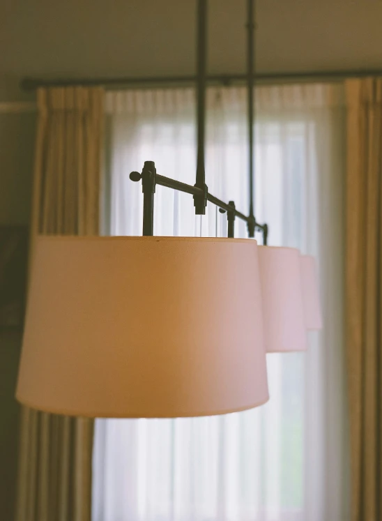 a lamp inside of a room with curtains