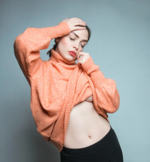 a young woman posing for a picture with her stomach exposed