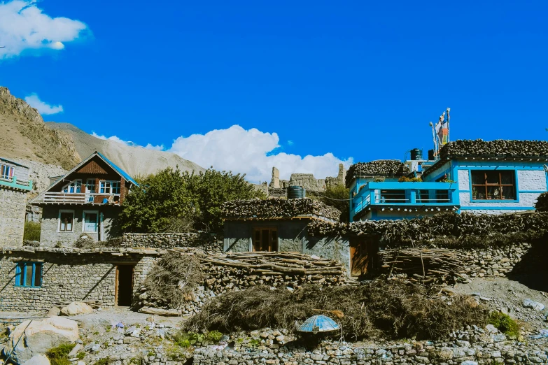 houses with mountains in the background and blue windows
