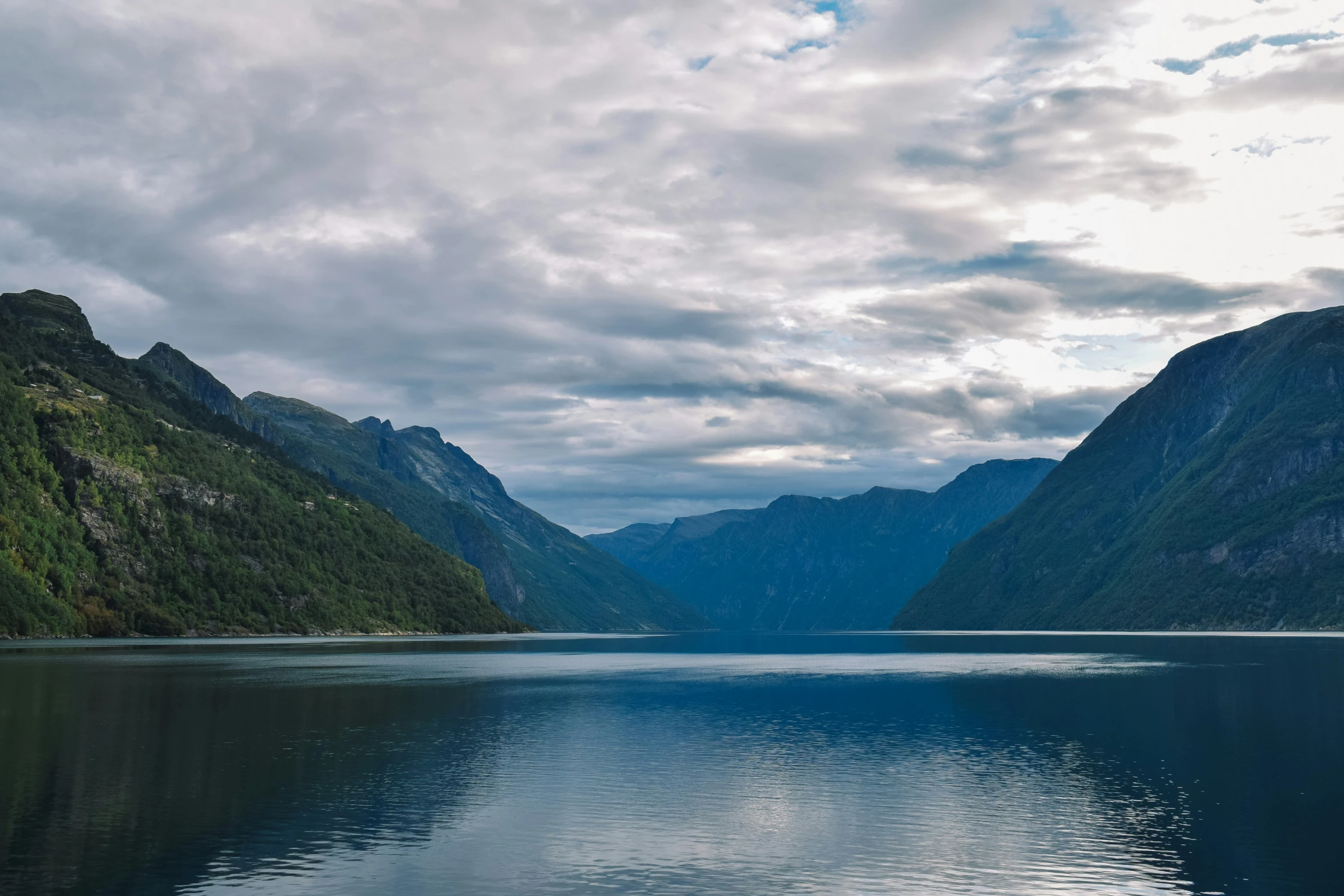 mountains reflecting in a still body of water