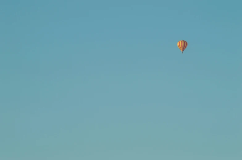 there are three  air balloons flying through the sky