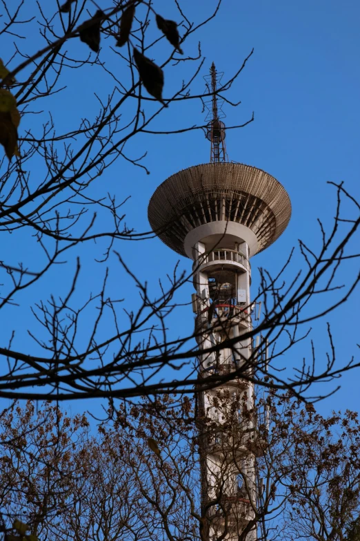 an upward view of a tower with a sky background