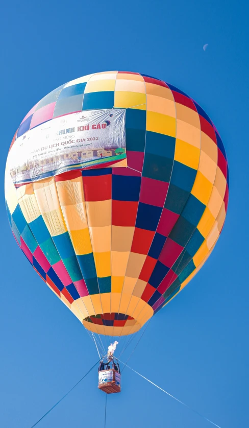 the colorful  air balloon was floating over the ground