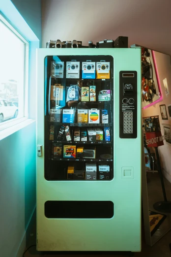 a vending machine sits next to a window