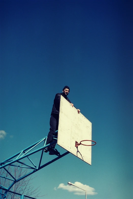 man in black jacket jumping up into the air with basketball