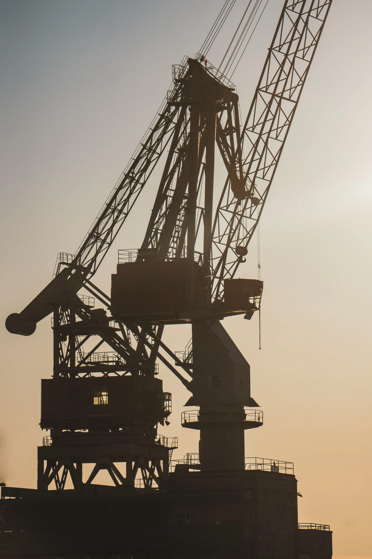 a giant crane is standing next to a large building