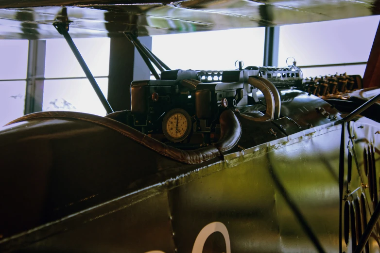 an old airplane sitting in a museum with lots of other things